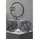 Round rough bronze abstract aluminium sculpture with circular base.