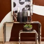 Large red marble obelisk with white veining on a minimalist geometric form.
