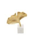 Gold ginkgo leaf sculpture on white marble base – botanical-inspired décor accent.