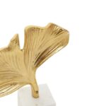 Gold ginkgo leaf sculpture on white marble base – botanical-inspired décor accent.