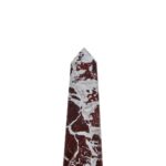Large red marble obelisk with white veining on a minimalist geometric form.