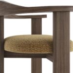 Contemporary armchair with a walnut-finished wood frame and Havana-coloured cushion in VEROTEX fabric, designed for modern, eco-conscious interiors.