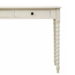 Ivory pine desk with spindle legs and two drawers with metallic knob handles.