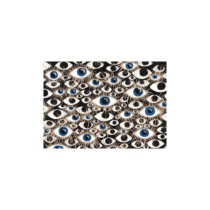 Framed abstract painting with blue and gold eyes on a black background, symbolizing identity and presence.