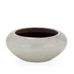 Low-profile off-white ceramic planter with wide opening and drainage hole, ideal for modern indoor or outdoor spaces.