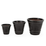 Set of three matte black rounded flower pots in different sizes, ideal for modern indoor or outdoor plant styling.