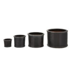 Set of four grey glazed ceramic planters in descending sizes, with a smooth cylindrical design, ideal for contemporary planting.