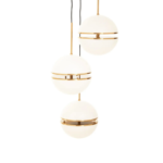 Three-globe pendant light in brushed brass finish with split glass design for soft diffusion, creating a modern and luxurious lighting statement.