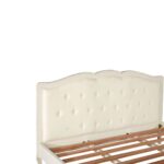 White carved wooden bed with upholstered buttoned panels, featuring a rustic weathered finish and bohemian French-inspired design.