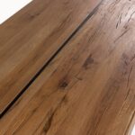 Large oakwood and black metal dining table with industrial design, handcrafted from natural wood with a sleek iron base.