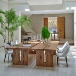 Large oakwood and black metal dining table with industrial design, handcrafted from natural wood with a sleek iron base.