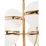 Four-globe brass pendant light with split-shade design and modern brushed finish, suspended on an elegant frame for ambient statement lighting.