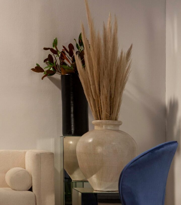 a high quality beige vase with sea grass and luxury interior