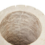 Alt text: TIBBOR Travertine Ribbed Vase in natural limestone with ribbed design and earthy veining, sculptural travertine vase for modern and classic interiors.