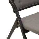 BRUMA Grey and Black Elm Wood Folding Chair with cushioned seat and backrest, modern black elm wood folding chair with grey fabric upholstery, space-saving folding chair with angular frame and soft curved backrest.