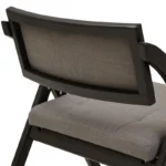 BRUMA Grey and Black Elm Wood Folding Chair with cushioned seat and backrest, modern black elm wood folding chair with grey fabric upholstery, space-saving folding chair with angular frame and soft curved backrest.