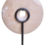 NAVIS Beige Marble Sculpture – polished cream marble disc with natural veining on black metal stand.
