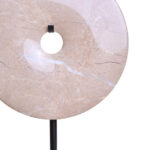 NAVIS Beige Marble Sculpture – polished cream marble disc with natural veining on black metal stand.