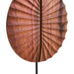 SOREL Brown Wooden Sculpture – handcrafted carved wood disc with radiating segments mounted on black metal base.