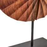 SOREL Brown Wooden Sculpture – handcrafted carved wood disc with radiating segments mounted on black metal base.