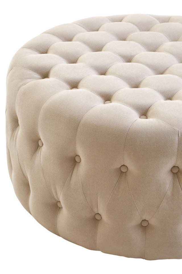 LUCRA Beige Velvet Footstool – round beige velvet footstool with button tufting and foam padding.