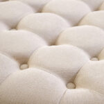 LUCRA Beige Velvet Footstool – round beige velvet footstool with button tufting and foam padding.