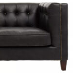 Alt text: VURO Three Seat Black Leather Sofa in antique ebony leather with button tufted back, Chesterfield-inspired three-seat sofa with oak wood legs, elegant black leather sofa for modern and classic interiors.