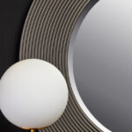 DERVIO Grey Ribbed Round Wall Mirror with contemporary textured grey frame hanging in a modern living room interior.