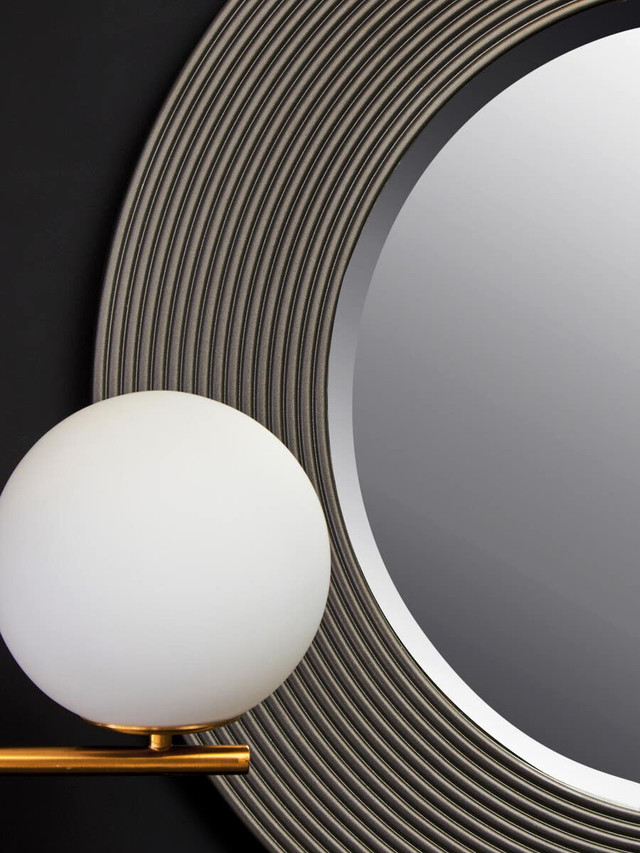 DERVIO Grey Ribbed Round Wall Mirror with contemporary textured grey frame hanging in a modern living room interior.
