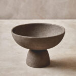VIRA Small Textured Grey Aluminium Pedestal Bowl with elevated base and tactile finish displayed on a modern console table.