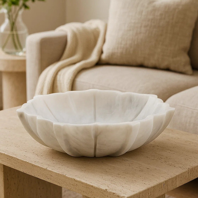 LOTUS Small White Marble Bowl with sculpted lotus-petal edges and polished finish displayed on a modern console table. LIFESTYLE IMAGE
