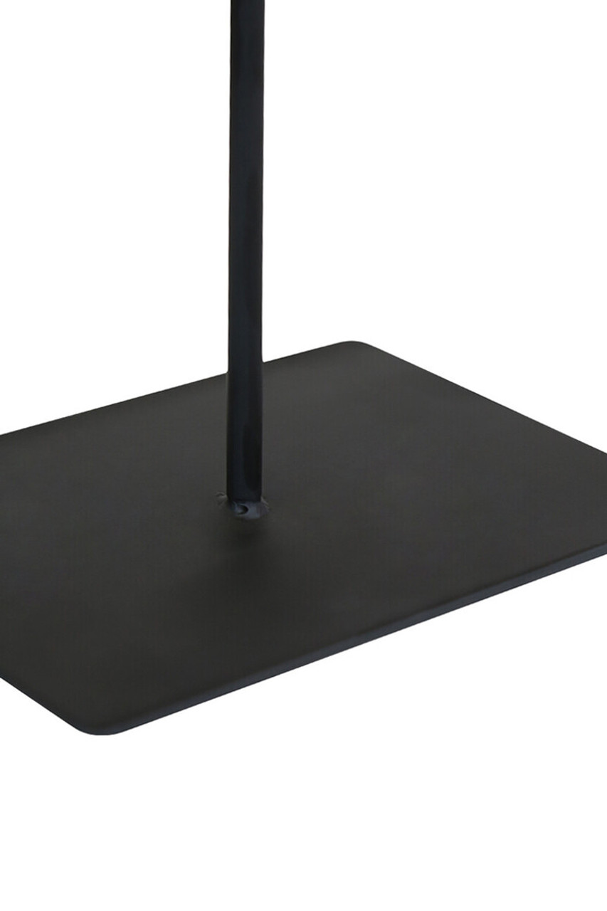 TIBOR Travertine Disc Sculpture featuring a hand-carved circular travertine stone on a sleek black metal base, displayed in a modern living room.