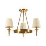 ZINA Ceiling Light with warm metallic frame and three white linen shades casting a soft ambient glow in a modern dining room.