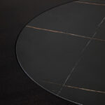 HUGO Round Veneer and Ceramic Dining Table with black marble-effect lazy susan and grey brushed stainless steel base displayed in a modern dining room.