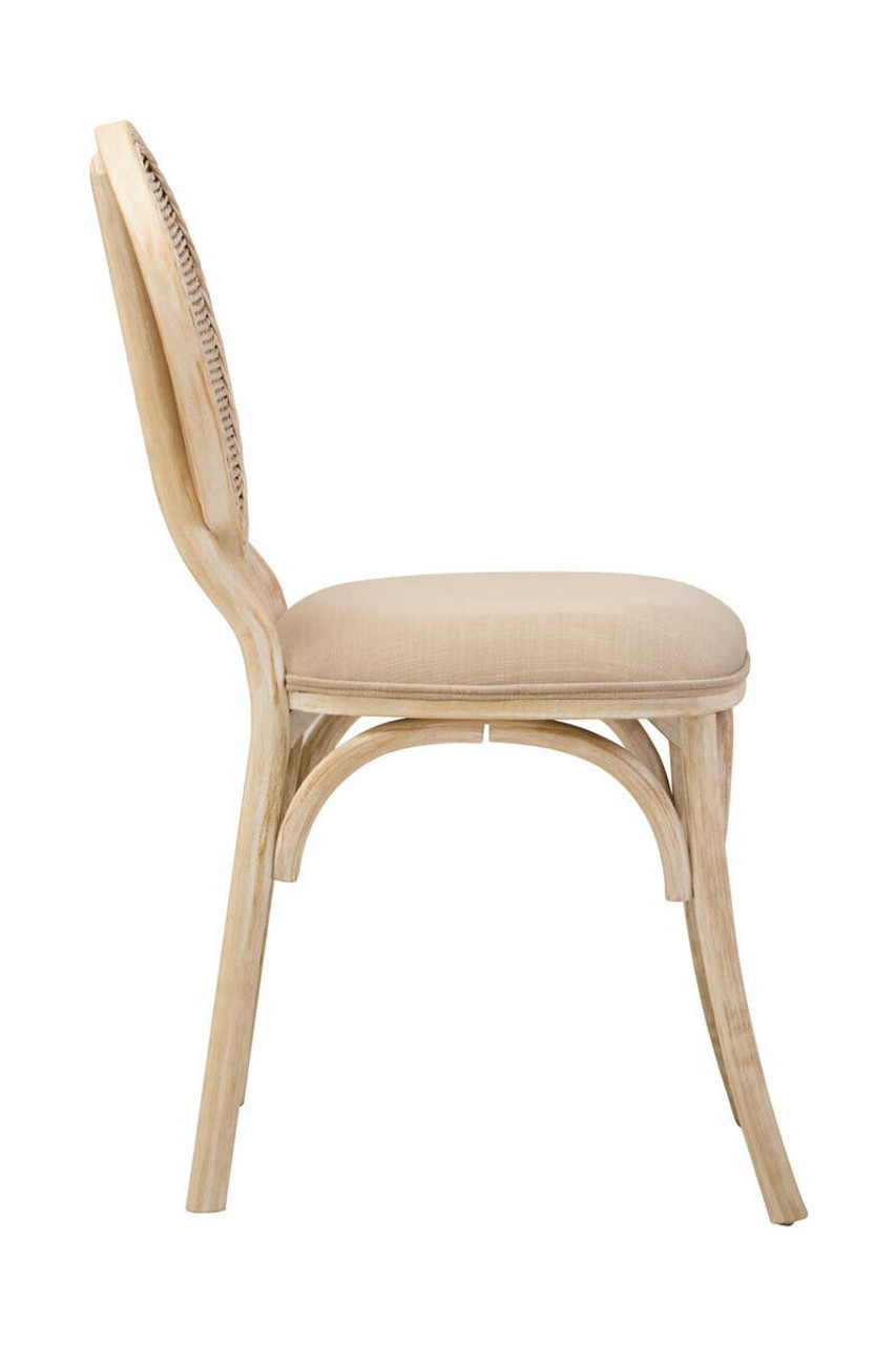 WALTON White Wash Elm Wood Dining Chair featuring cane woven backrest and beige cushioned seat styled in a bright modern dining room.