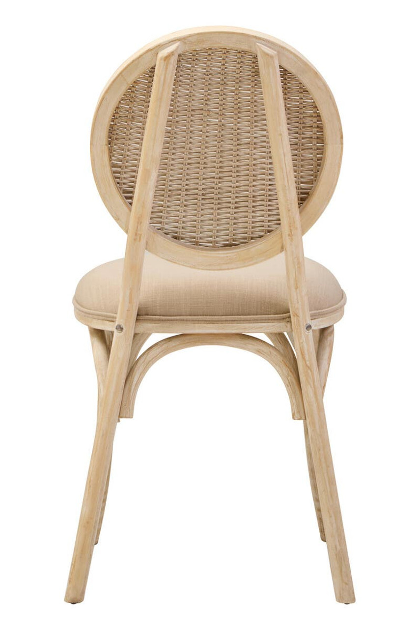 WALTON White Wash Elm Wood Dining Chair featuring cane woven backrest and beige cushioned seat styled in a bright modern dining room.