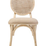 WALTON White Wash Elm Wood Dining Chair featuring cane woven backrest and beige cushioned seat styled in a bright modern dining room.