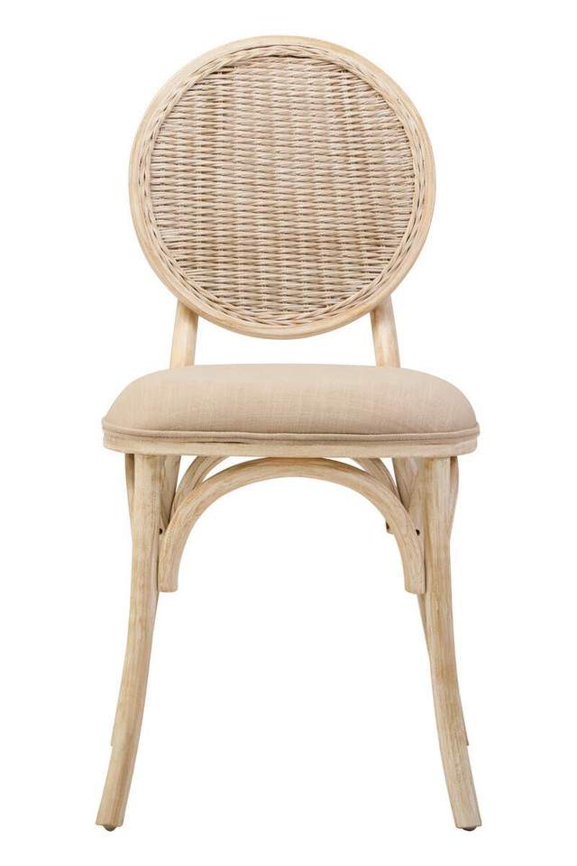 WALTON White Wash Elm Wood Dining Chair featuring cane woven backrest and beige cushioned seat styled in a bright modern dining room.