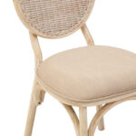 WALTON White Wash Elm Wood Dining Chair featuring cane woven backrest and beige cushioned seat styled in a bright modern dining room.