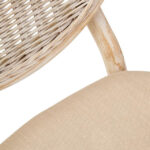 WALTON White Wash Elm Wood Dining Chair featuring cane woven backrest and beige cushioned seat styled in a bright modern dining room.