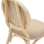 WALTON White Wash Elm Wood Dining Chair featuring cane woven backrest and beige cushioned seat styled in a bright modern dining room.
