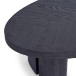 AUSTIN Oval Dining Table in black-brown oak with sculptural end legs and elegant oval top in a modern dining room setting.