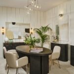 AUSTIN Oval Dining Table in black-brown oak with sculptural end legs and elegant oval top in a modern dining room setting.