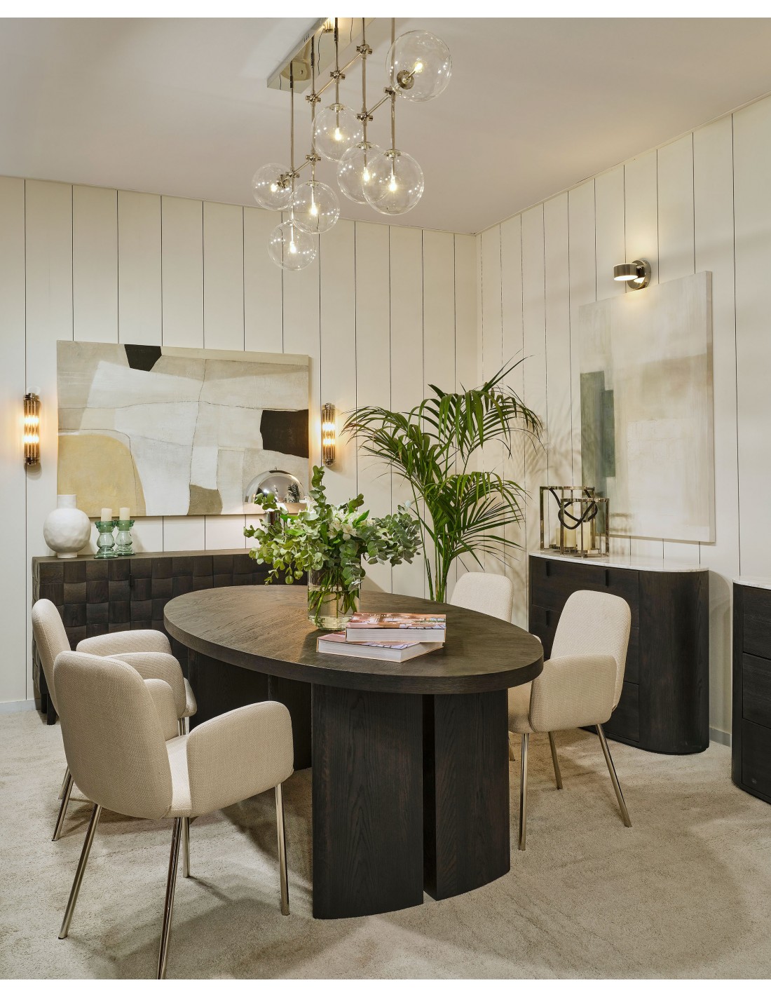 AUSTIN Oval Dining Table in black-brown oak with sculptural end legs and elegant oval top in a modern dining room setting.