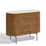 MARIETA White Marble Chest of Drawers featuring natural oak wood frame, gold-tone handles and legs, and an oval white marble top.