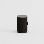 NOEL Ash & Marble Bedside Table with dark ash wood base and elegant grey marble top beside a modern bed.