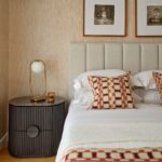 NOEL Ash & Marble Bedside Table with dark ash wood base and elegant grey marble top beside a modern bed.