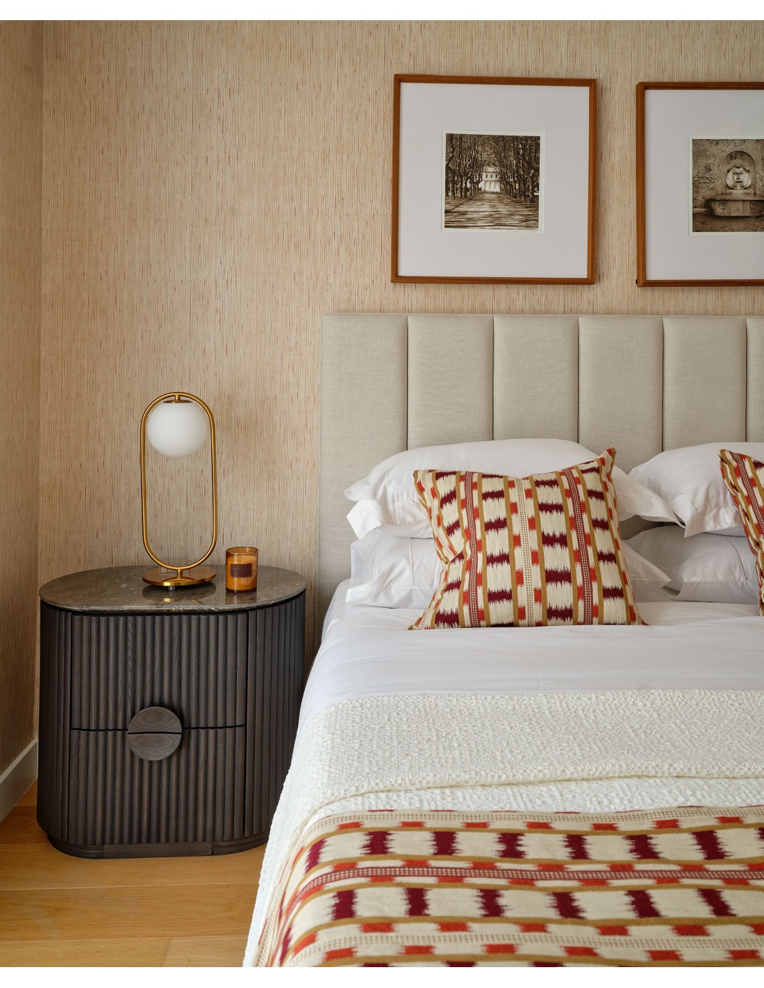 NOEL Ash &amp; Marble Bedside Table with dark ash wood base and elegant grey marble top beside a modern bed.