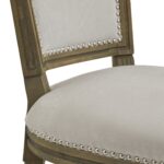 Ripley Grey Dining Chair with woven upholstery, washed wood frame, and silver stud detailing.