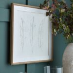 SOLLI White Feathers Art in champagne-beaded frame with raised feather impressions for contemporary and coastal interiors.